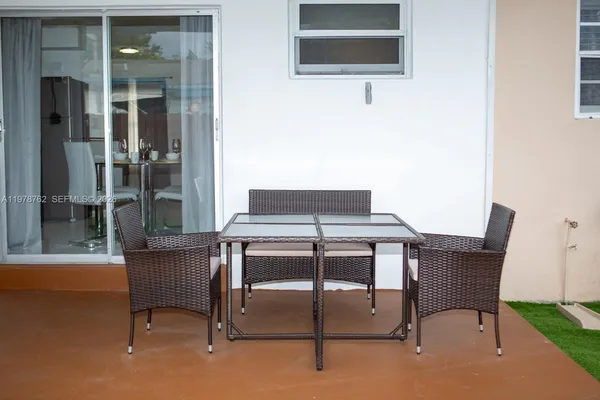 a view of a dining room with furniture and window