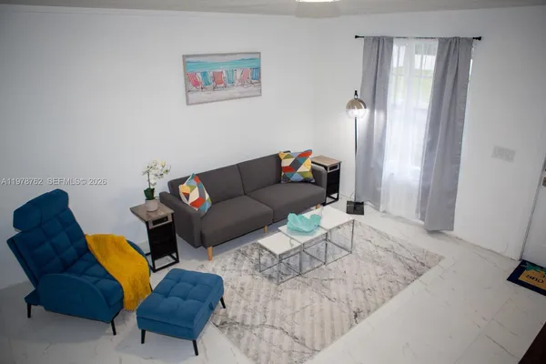a living room with furniture and a window