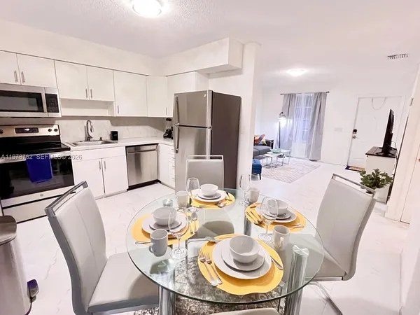 a kitchen with a dining table and chairs