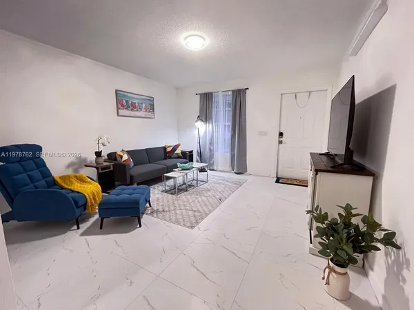 a living room with furniture and a flat screen tv