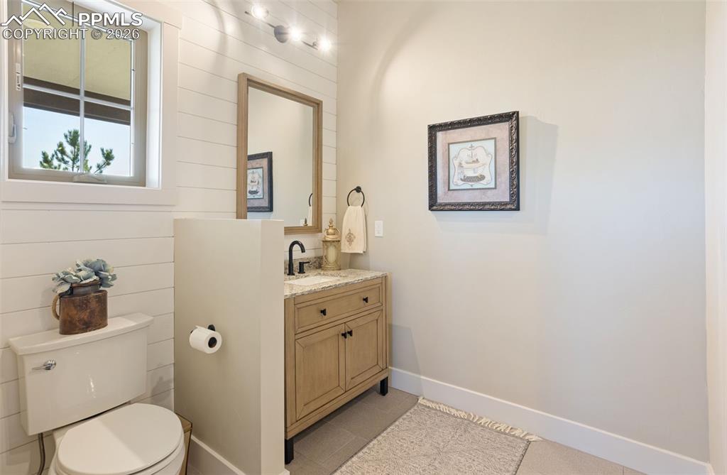 16835 Goshawk Road Colorado Springs, CO 80908 - Photo 17 of 50 a bathroom with a toilet sink and mirror