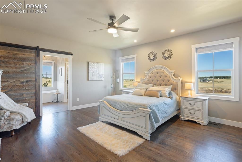 16835 Goshawk Road Colorado Springs, CO 80908 - Photo 21 of 50 a bedroom with a large bed and a window