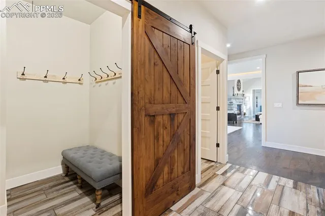 a view of hallway with wooden floor and stairs