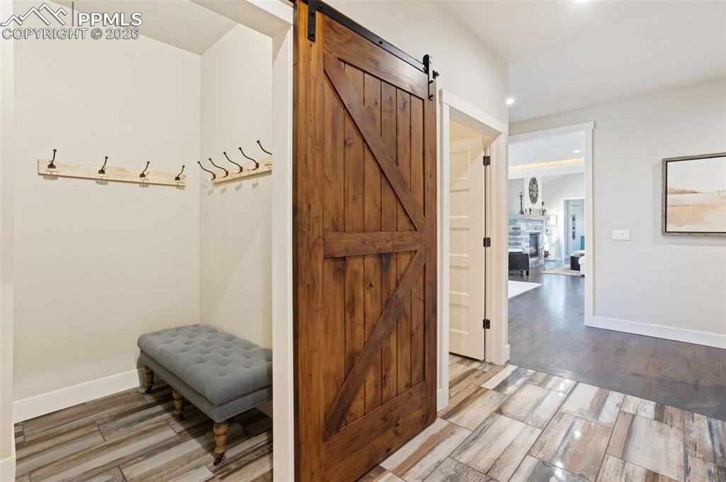 16835 Goshawk Road Colorado Springs, CO 80908 - Photo 25 of 50 a view of hallway with wooden floor and stairs