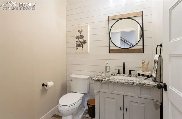 a bathroom with a toilet a sink and a mirror