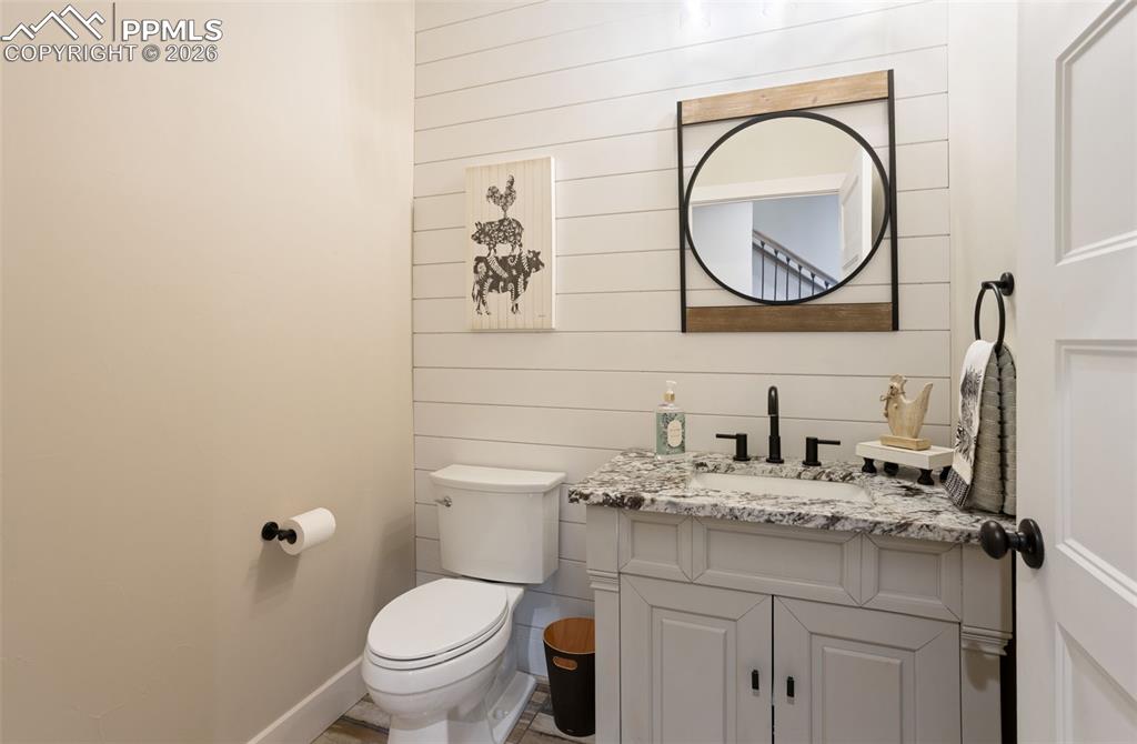 16835 Goshawk Road Colorado Springs, CO 80908 - Photo 27 of 50 a bathroom with a toilet a sink and a mirror