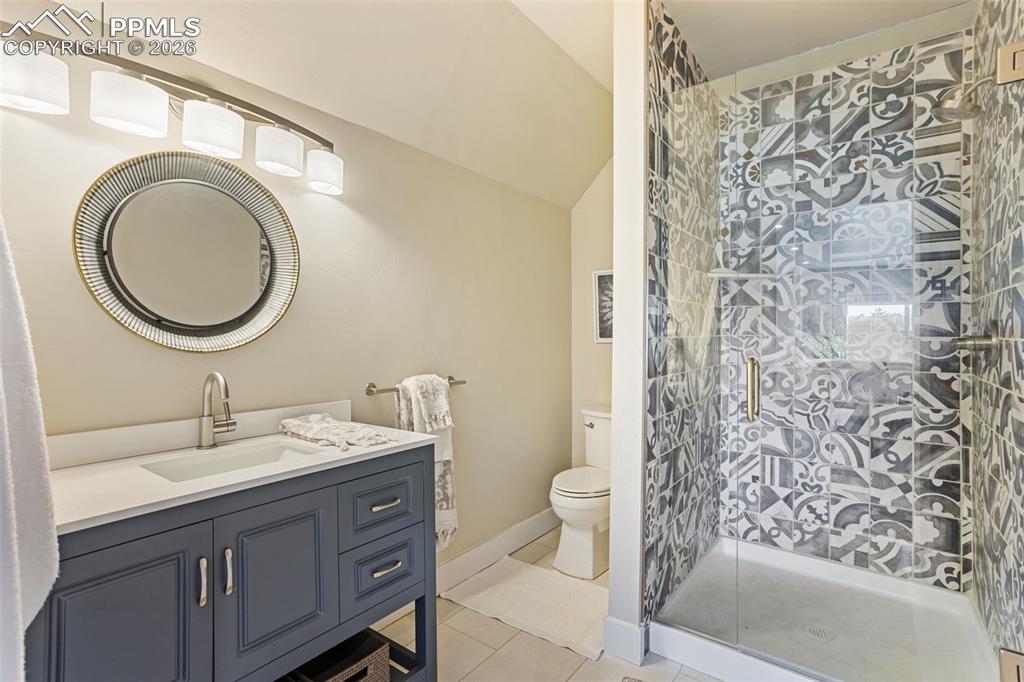 16835 Goshawk Road Colorado Springs, CO 80908 - Photo 30 of 50 a bathroom with a sink a toilet and a mirror