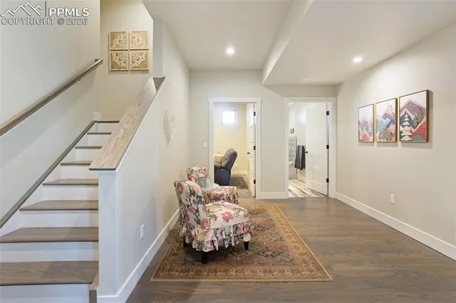 a living room with furniture and stairs