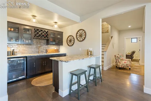 a kitchen with a sink cabinets and wooden floor