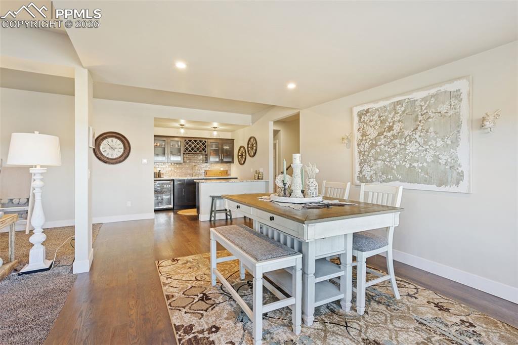 16835 Goshawk Road Colorado Springs, CO 80908 - Photo 36 of 50 a view of a dining room with furniture and wooden floor