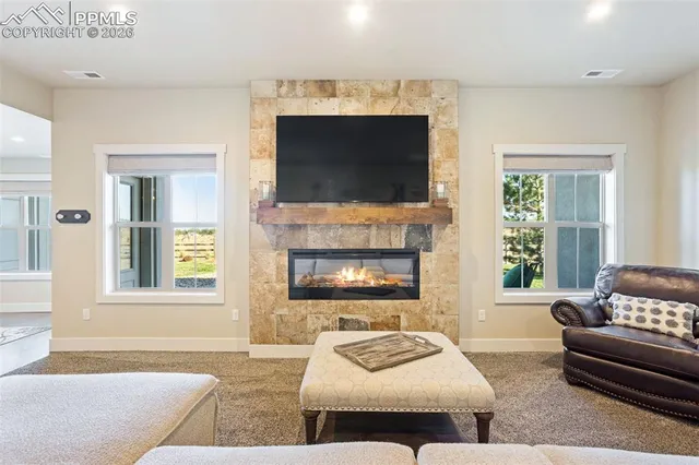 a living room with furniture and a fireplace