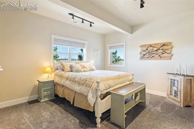 a spacious bedroom with a bed and a window