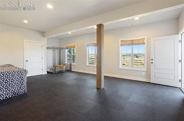 an empty room with windows and closet