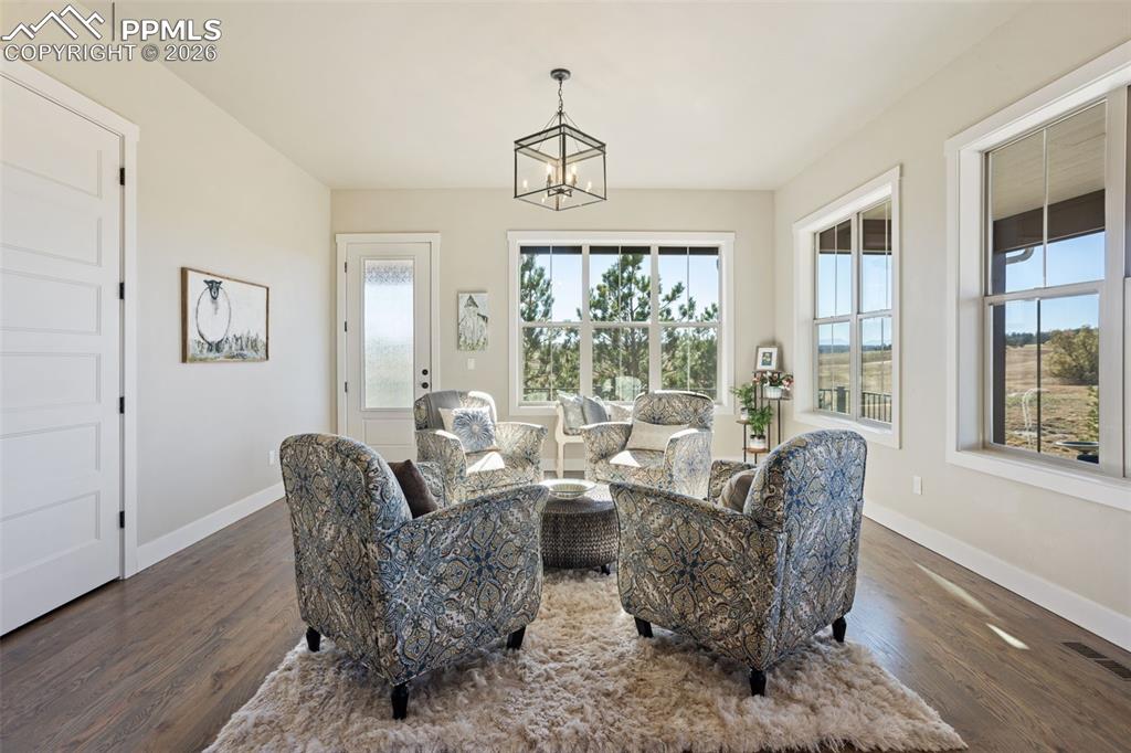 16835 Goshawk Road Colorado Springs, CO 80908 - Photo 5 of 50 a living room with furniture a chandelier and a window