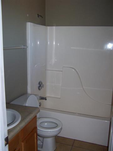 884 Elote Court, Unit CORTE Rio Rico, AZ 85648 - Photo 7 of 13 a bathroom with a granite countertop sink toilet and shower