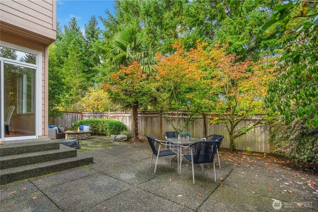 a view of a patio with table and chairs and potted plants