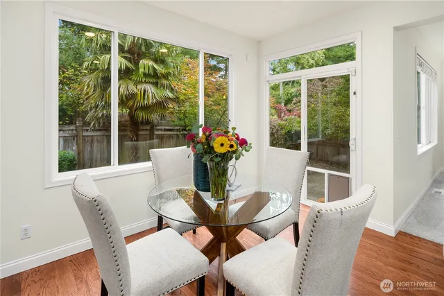 a dining room with furniture wooden floor and a potted plant