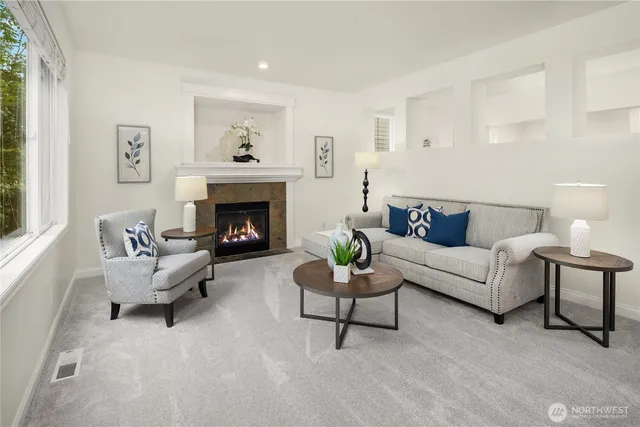 a living room with furniture and a fireplace