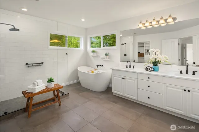 a spacious bathroom with a double vanity sink and a mirror