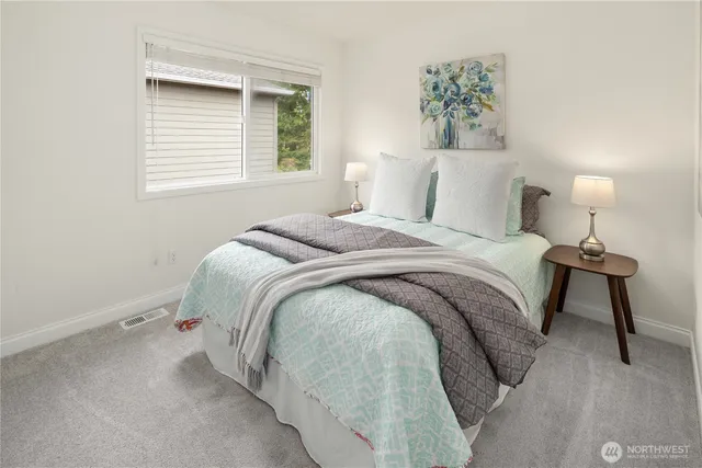 a bedroom with a bed and a night stand