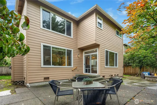 a view of a house with a backyard and sitting area