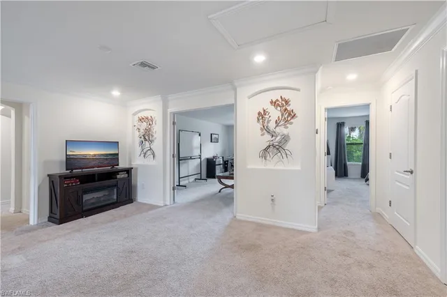 a room with furniture a air conditioner and a window