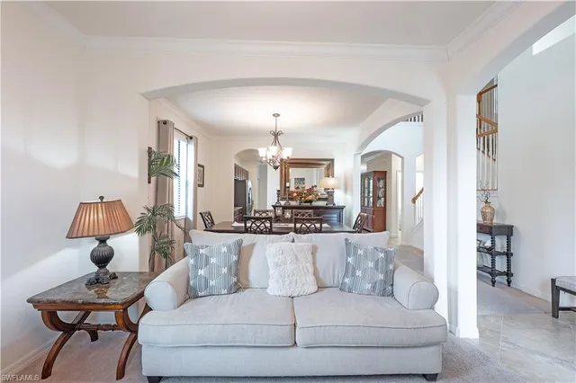 a living room with furniture and a chandelier