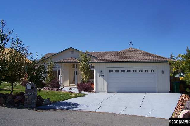 225 Koenig Road Reno, NV 89506 - Photo 1 of 9 a front view of a house with a yard and garage