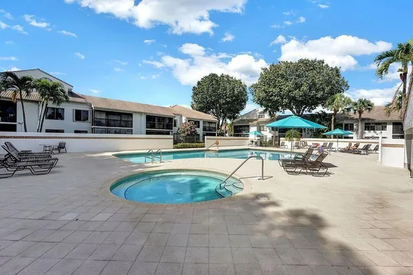 a swimming pool with outdoor seating and yard
