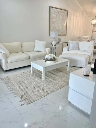 a living room with furniture and a lamp