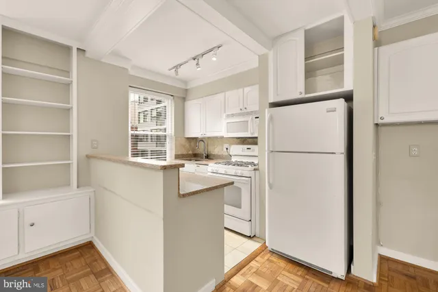 a kitchen with a stove a sink and a cabinets