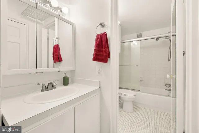 a view of a hallway with windows and chandelier