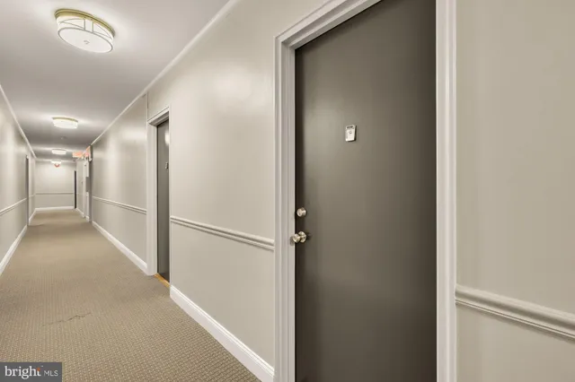 a view of hallway with wooden floor