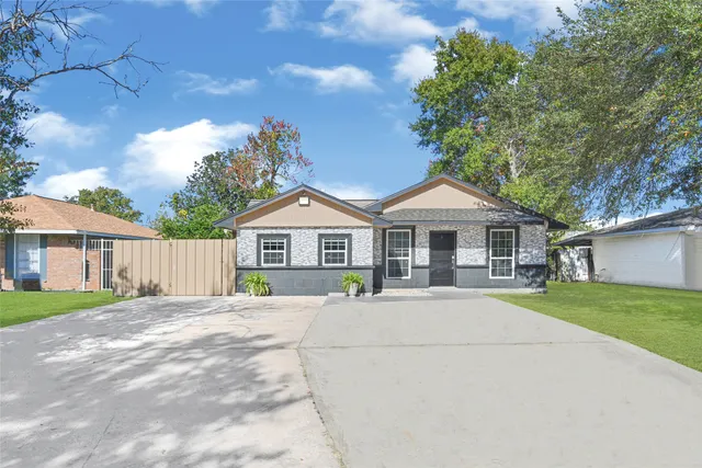 a front view of a house with yard and green space