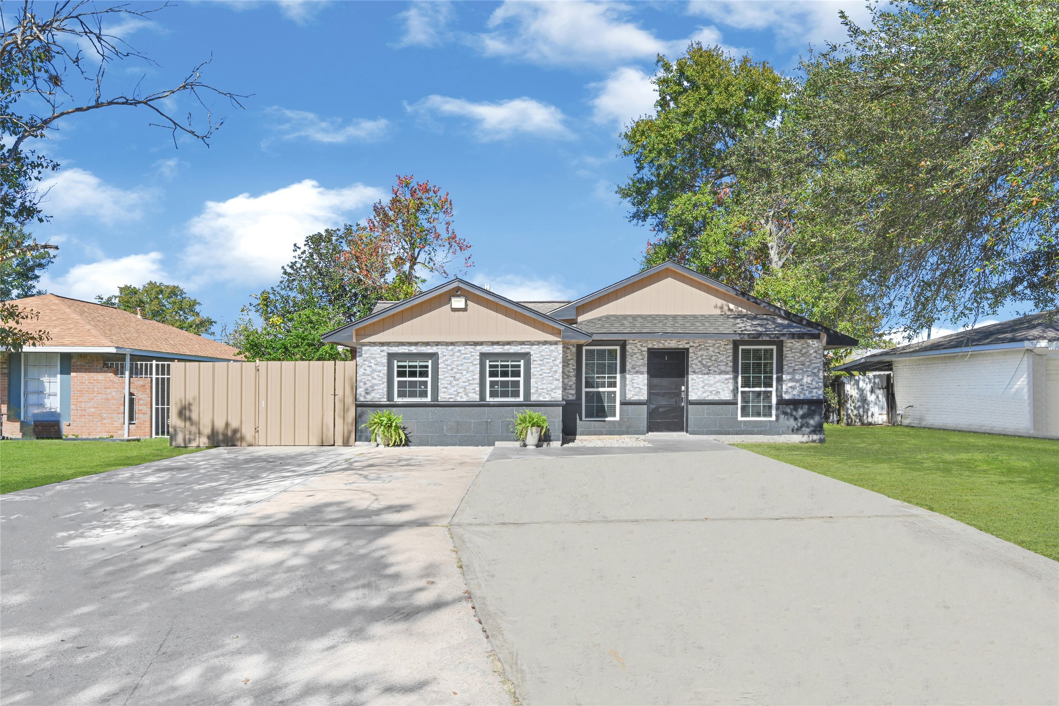 a front view of a house with yard and green space