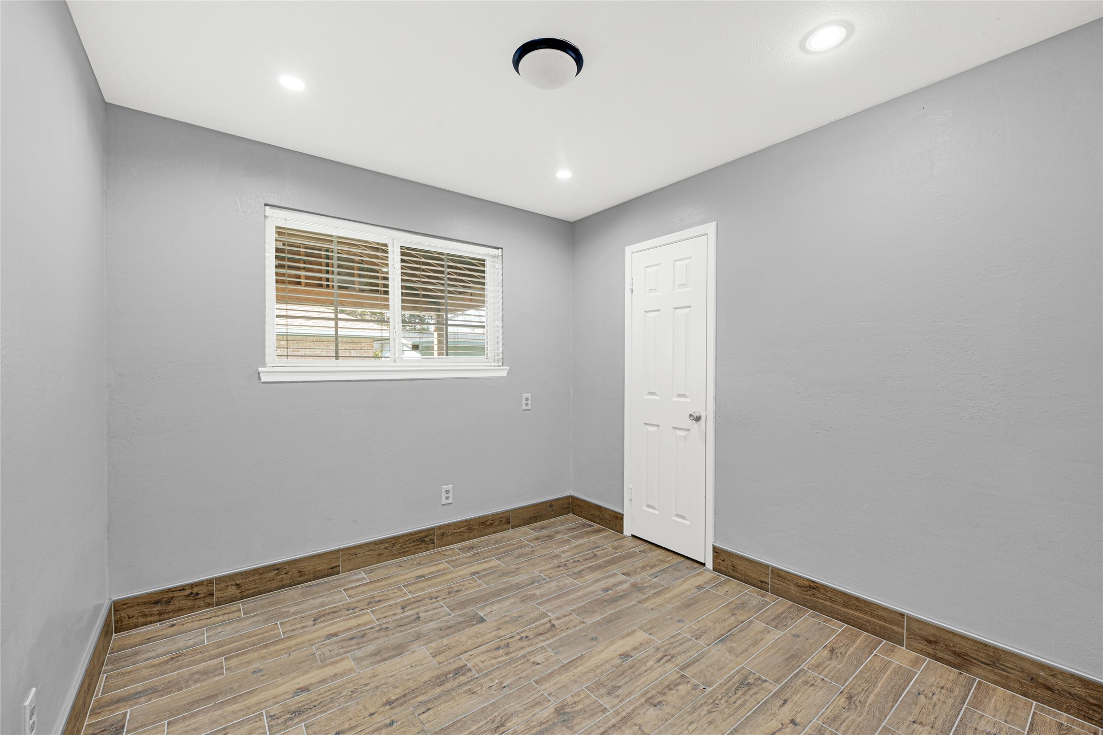 3603 Beau Lane Houston, TX 77039 - Photo 18 of 22 an empty room with wooden floor and windows
