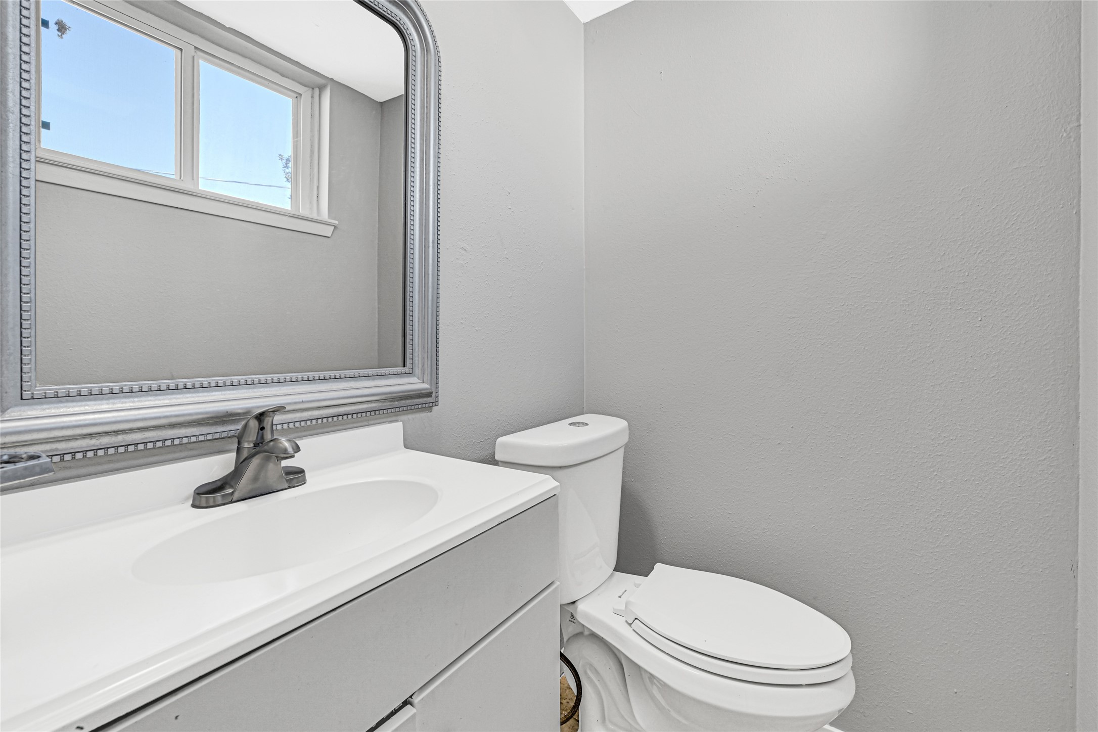 3603 Beau Lane Houston, TX 77039 - Photo 22 of 22 a bathroom with a sink a toilet and mirror