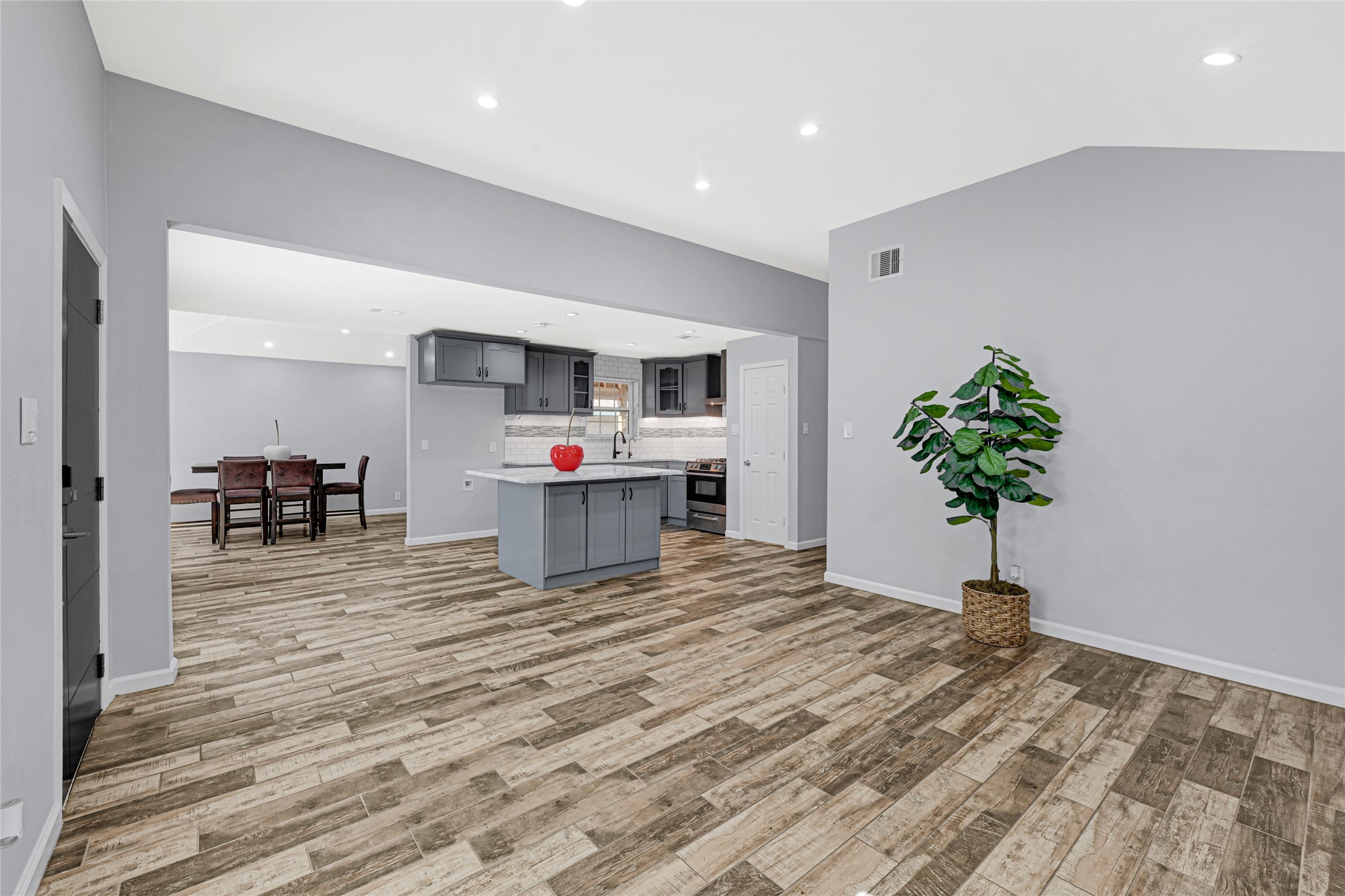 3603 Beau Lane Houston, TX 77039 - Photo 9 of 22 a living room with kitchen island furniture and a potted plant