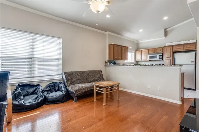 a living room with stainless steel appliances granite countertop furniture and a kitchen view