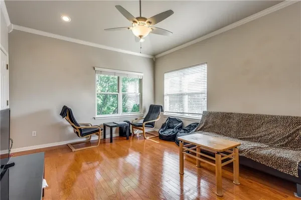 a living room with furniture flat screen tv and a large window