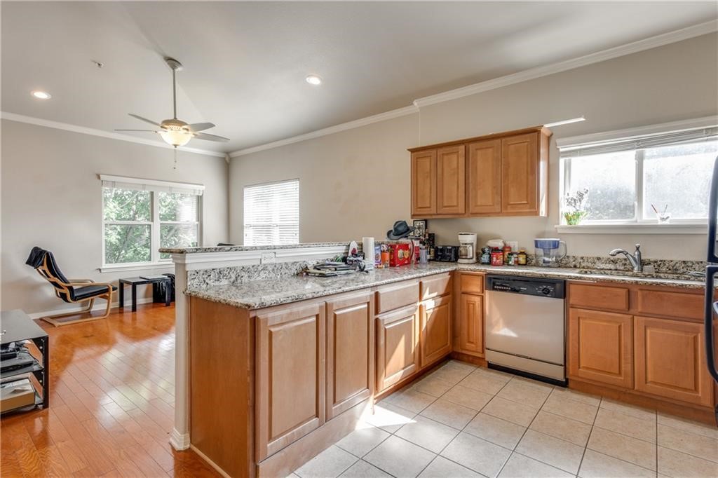 3011 Speedway, Unit 6 Austin, TX 78705 - Photo 5 of 11 a kitchen with stainless steel appliances granite countertop a stove top oven a sink dishwasher and white cabinets with wooden floor