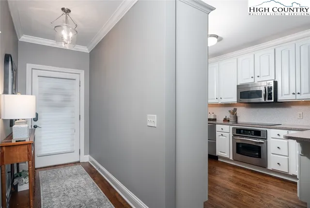 a kitchen with stainless steel appliances a stove top oven a sink and a refrigerator