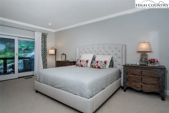 a bedroom with a bed and a large window