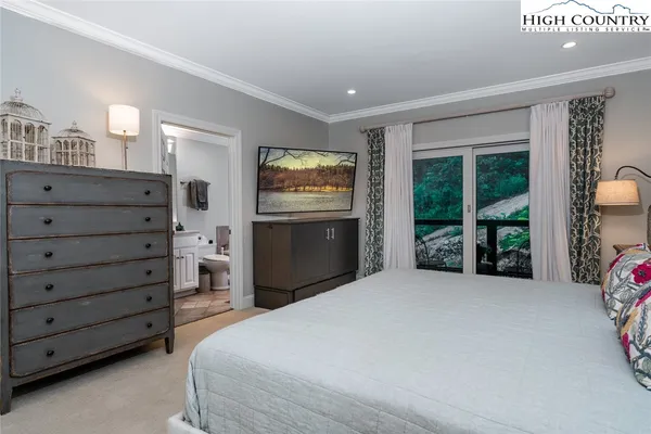 a large bed sitting in a bedroom next to a window