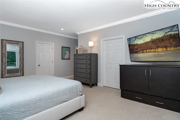 a bedroom with a bed and a television