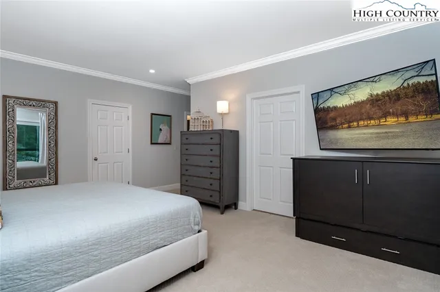 a bedroom with a bed and a television