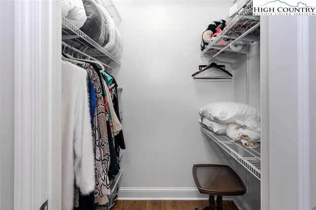 a view of walk in closet with clothes and shoes