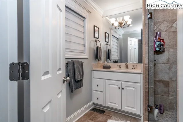 a bathroom with a double vanity sink a mirror and shower