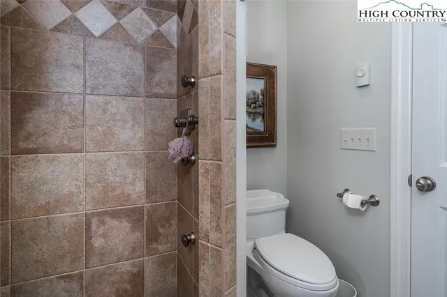 a white toilet sitting next to a bathroom sink