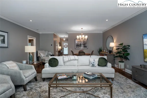 a living room with furniture lamp and rug